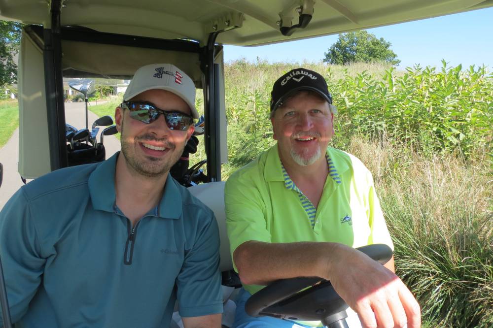 Two more men in golf cart